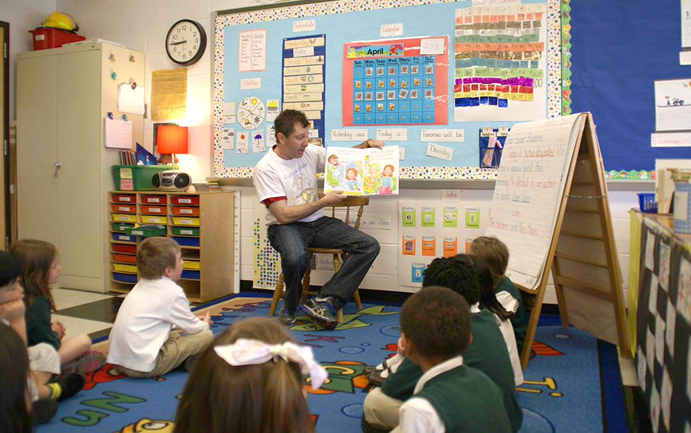 The author reading to a classroom of young students